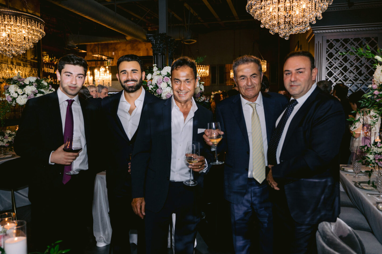 Men posing for a photo at a wedding reception at Cucina Venti