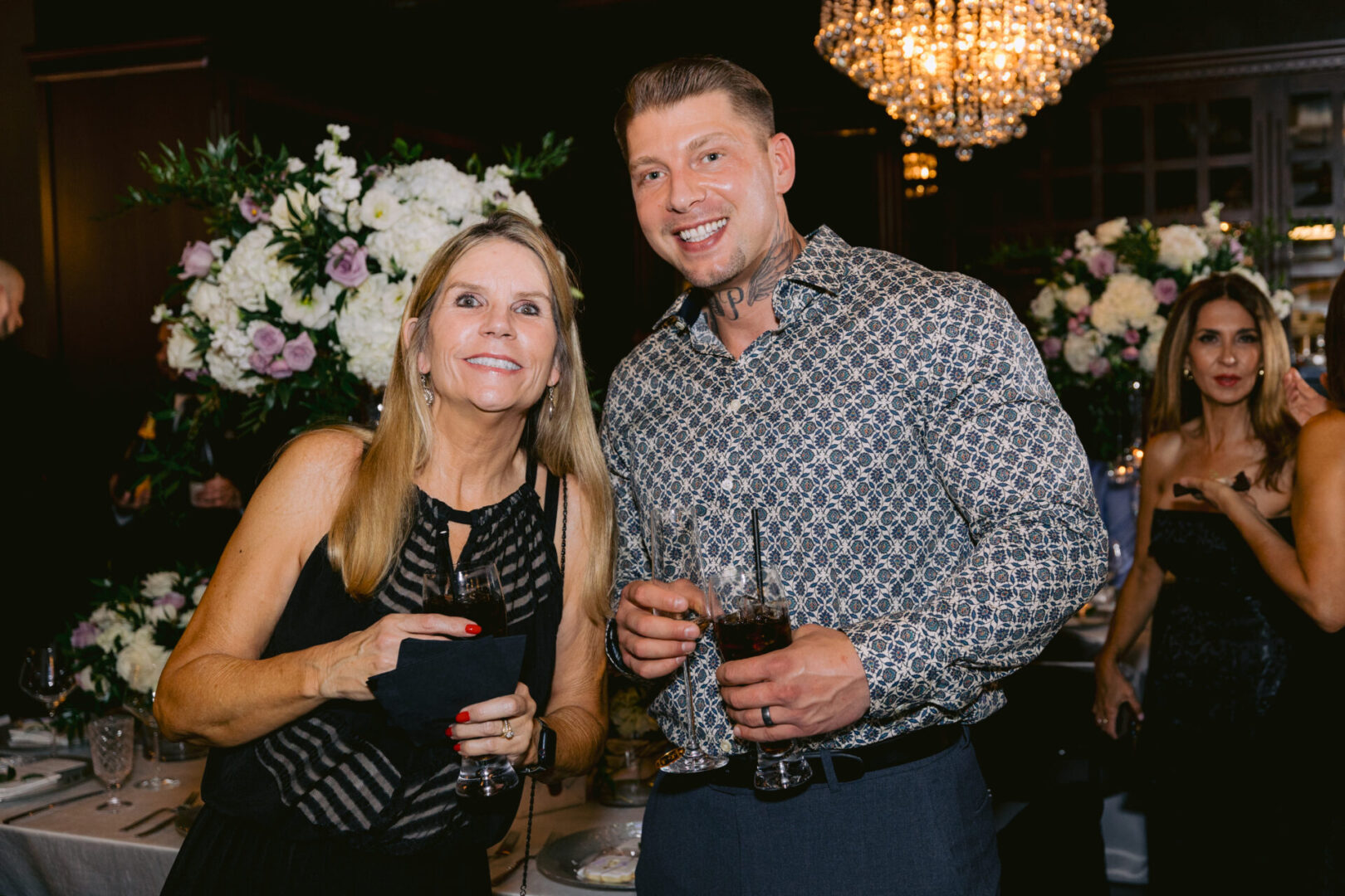 A Woman and Man posing for a photo during the reception party at Cucina Venti
