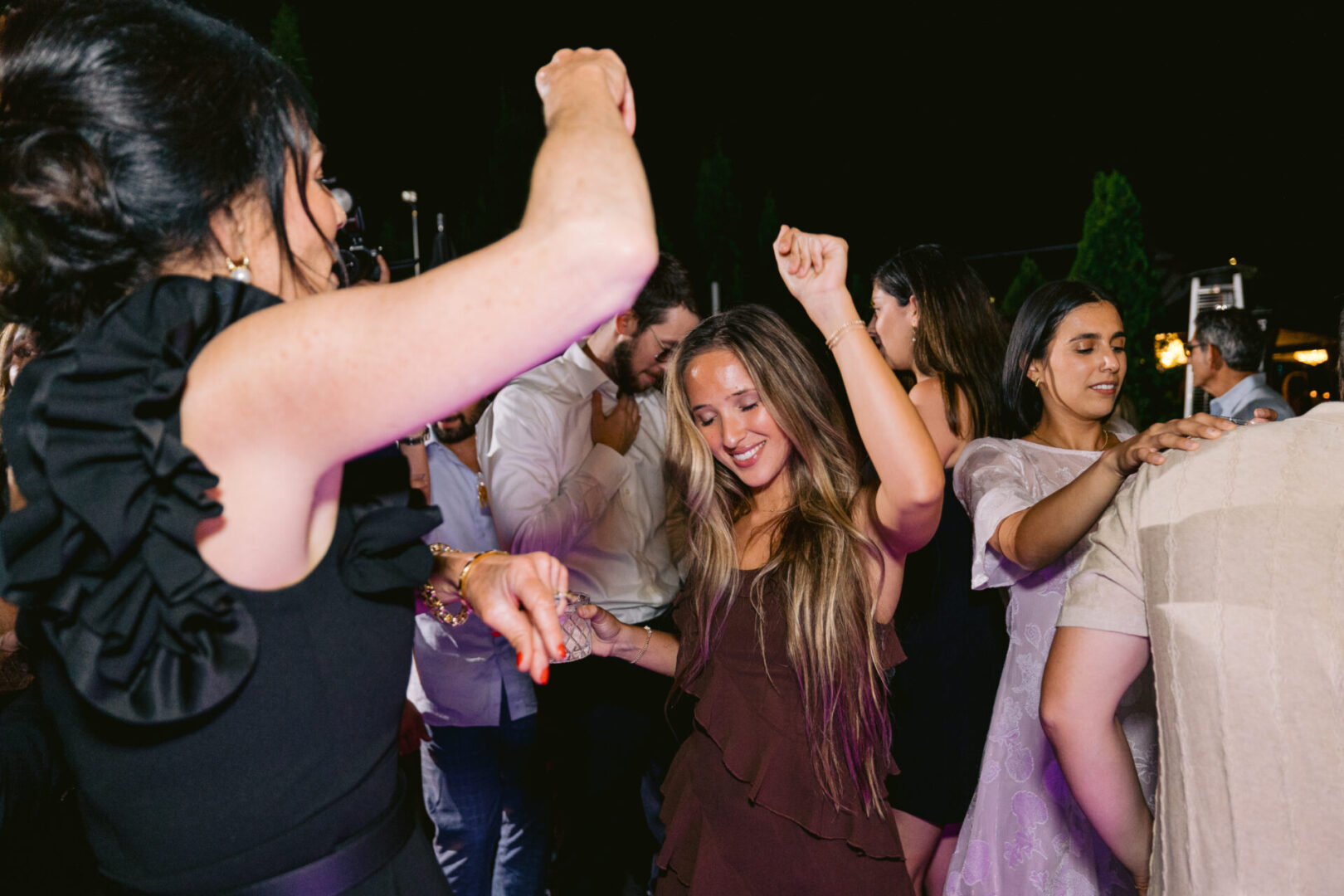 People, mostly women, dancing to DJ'd music at a wedding reception at Cucina Venti